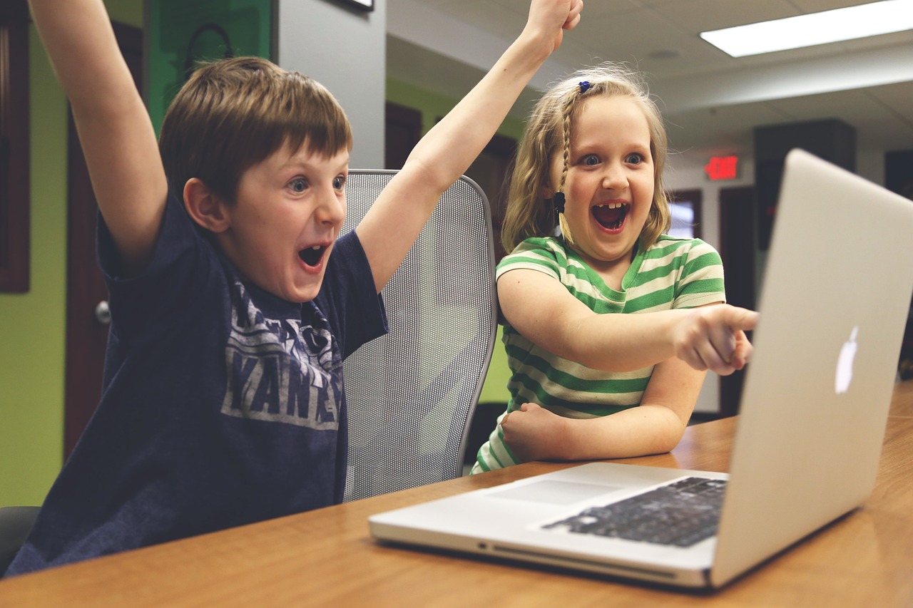 Kids cheering at laptop